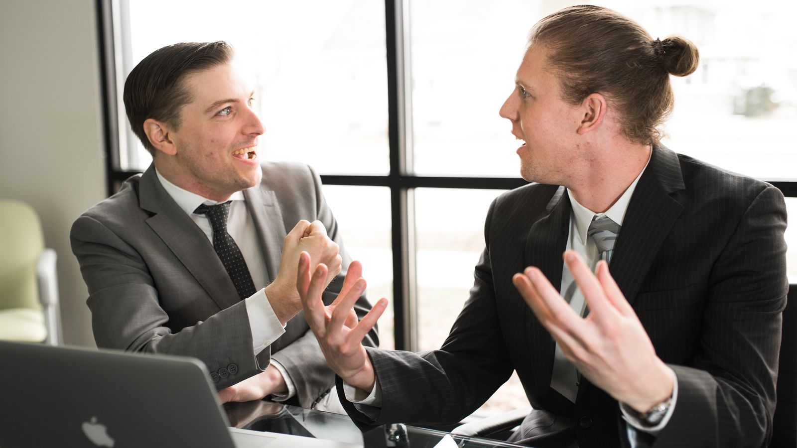 Two businessmen by a computer, succeeding sooner.